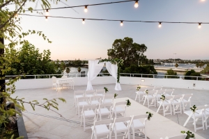 The Rooftop Terrace is a wedding venue at the Tradewinds Hotel with views of the Swan River and fairy lights overhead